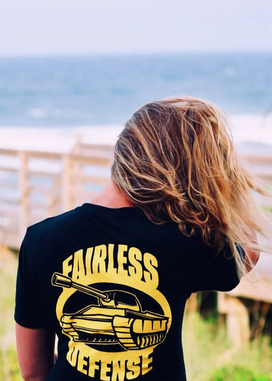 Fairless Defense black logo tee at the beach